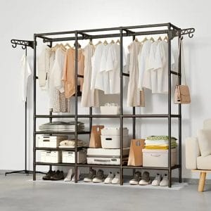 Clothes hanging on open metal closet in bedroom